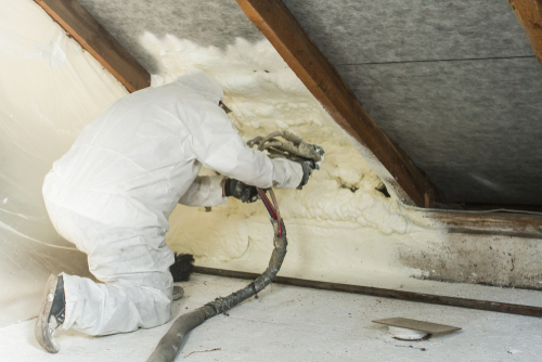 spraying on insulation to a roof